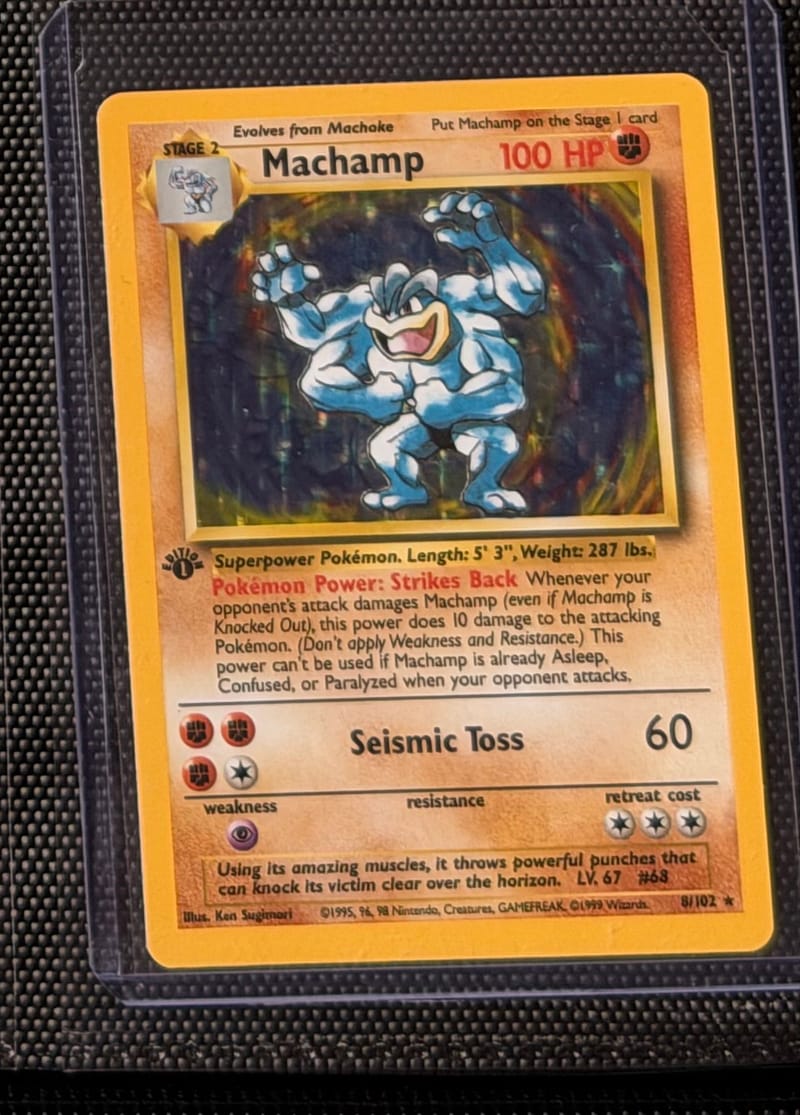 A Base Set Machamp 8/102 with the 1st Edition stamp, in a toploader