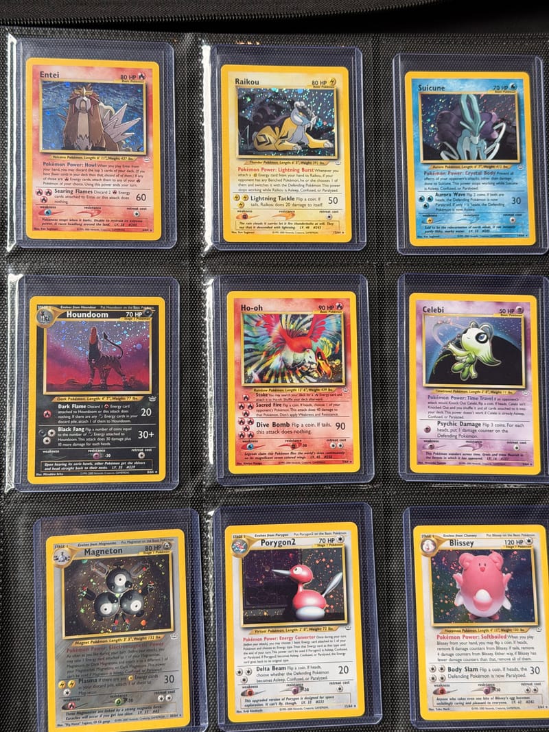 A binder page of Neo Revelation holos: Entei, Raikou, Suicune, Houndoom, Ho-oh, Celebi, Magneton, Porygon2 and Blissey